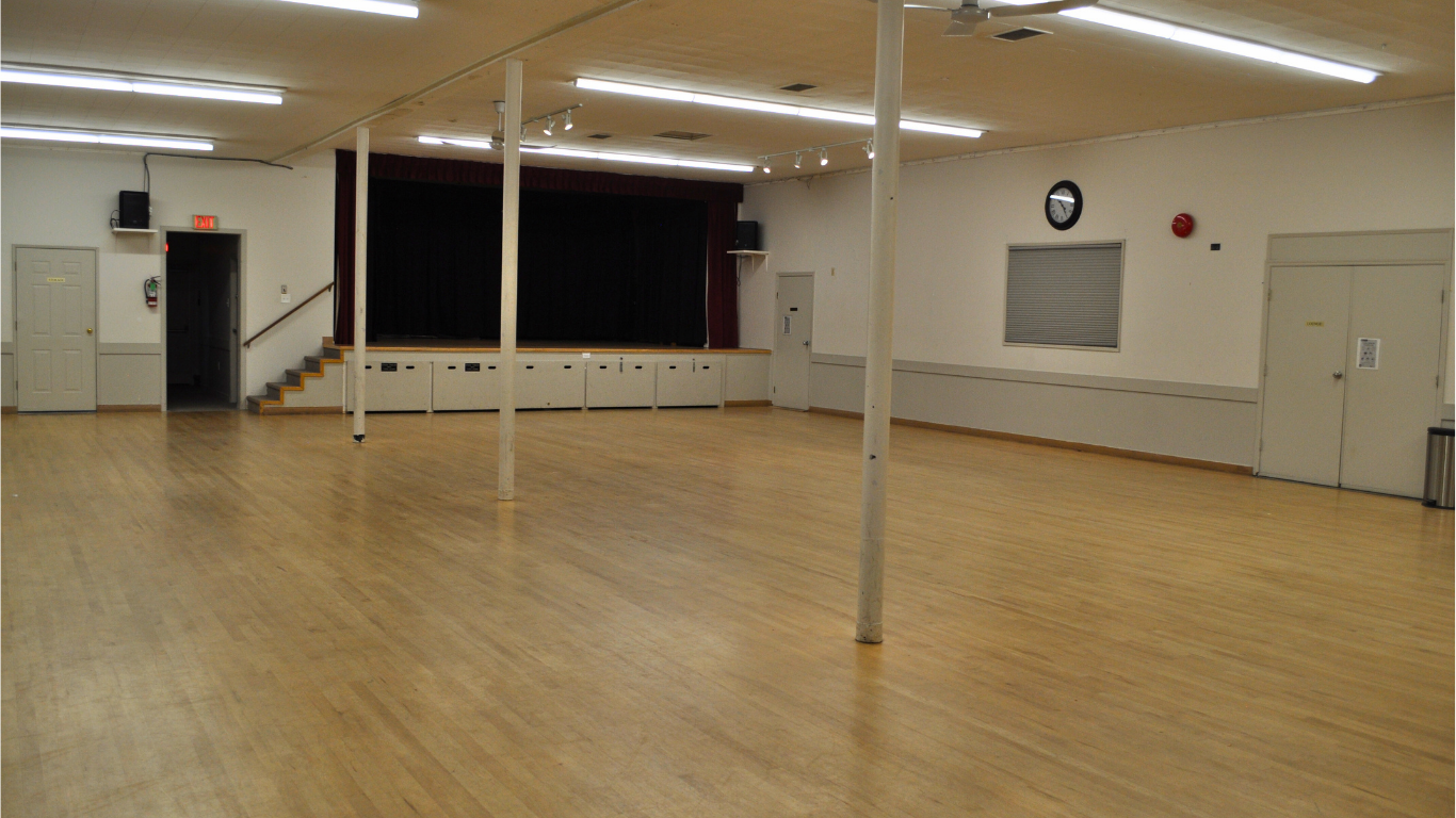 Main hall with small stage at front of room.