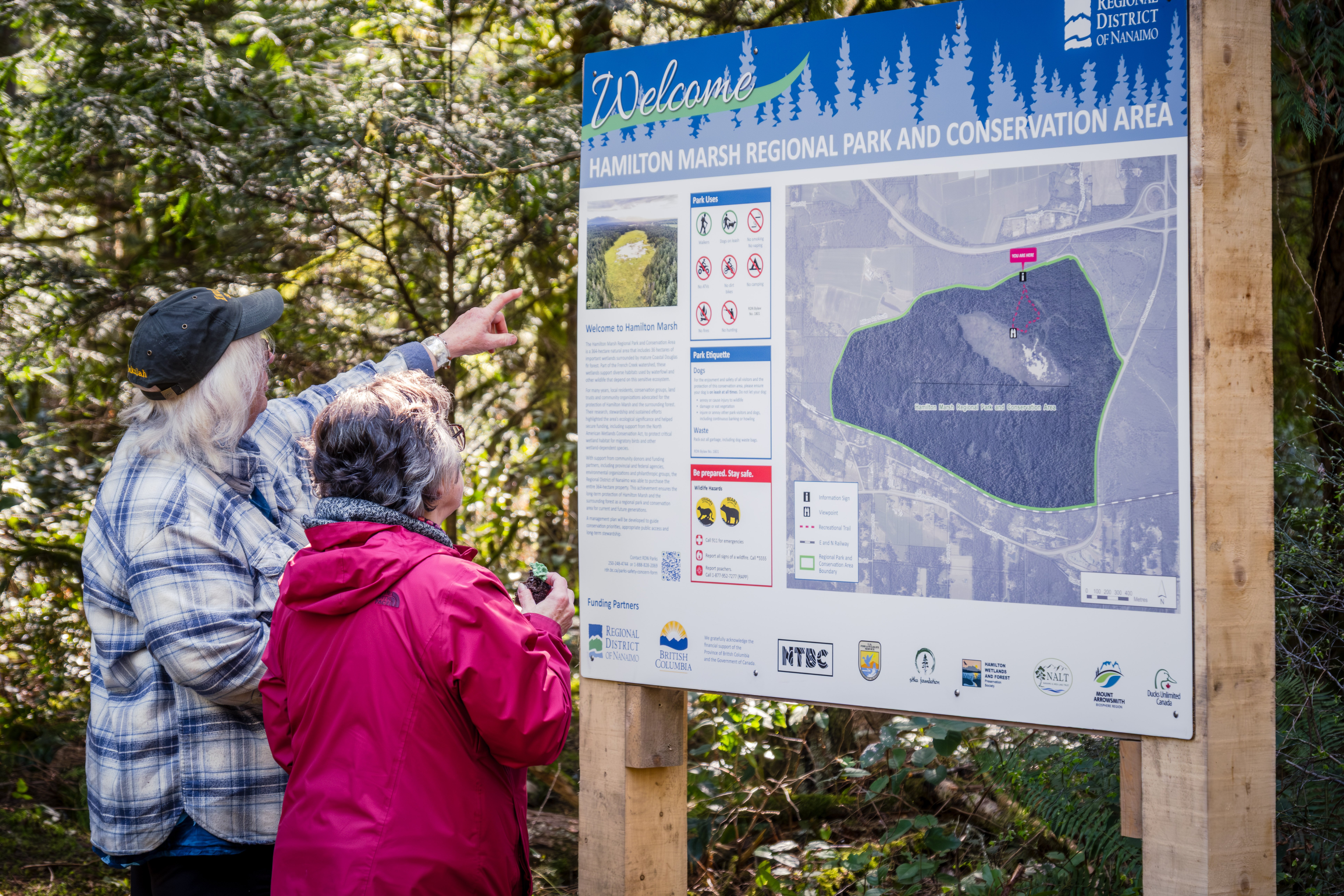 Opening ceremony guests viewing Hamilton Marsh sign