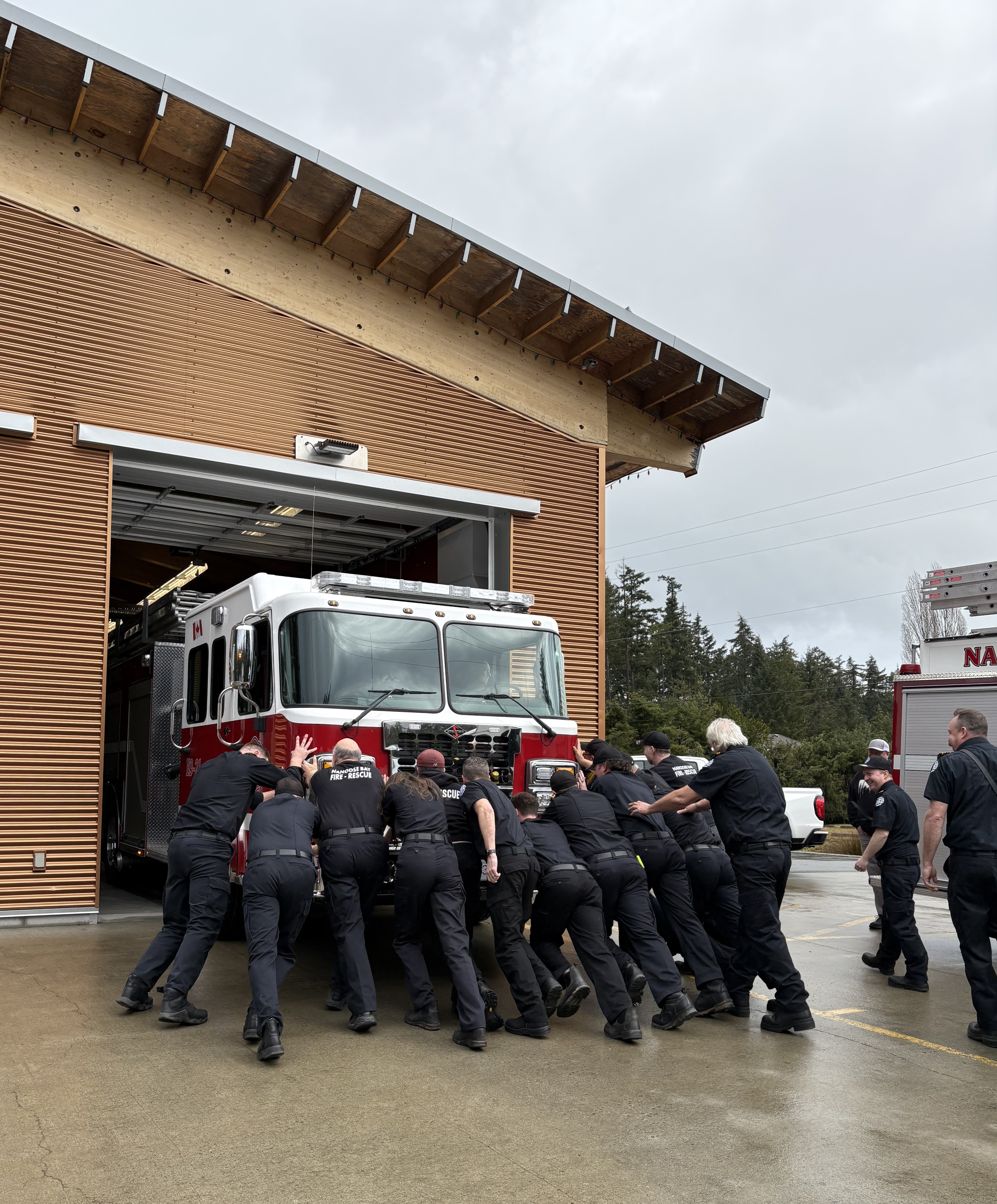 Nanoose Fire Department Firefighters Pushing In the New Fire Engine